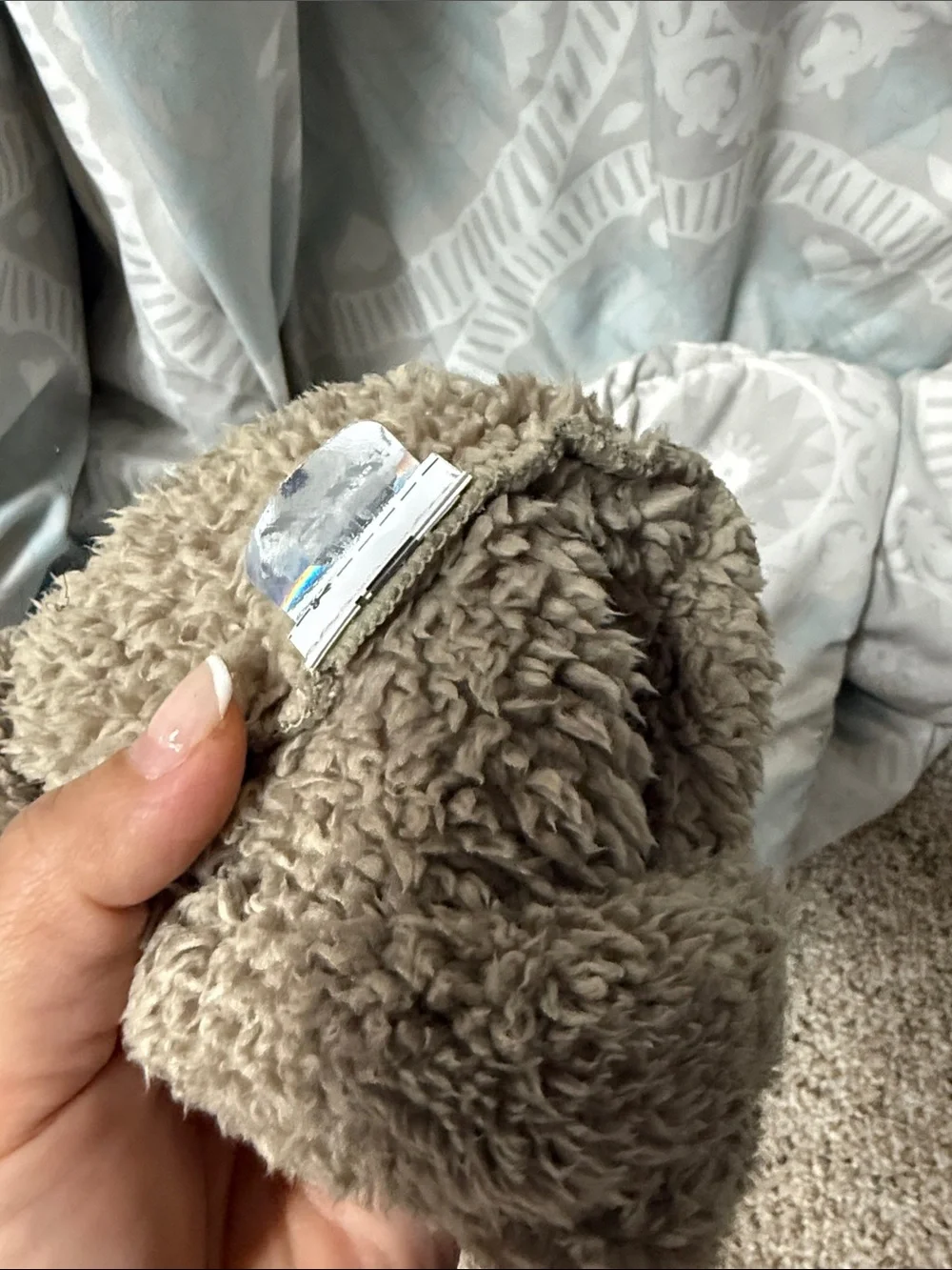 The North Face Kids Teddy Fleece Beanie Hat in Taupe with White Ear Accents. 3-6